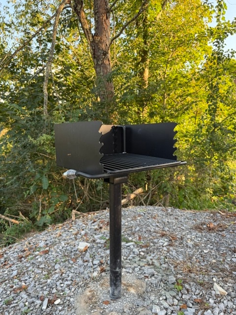 Black barbecue grill in forest setting