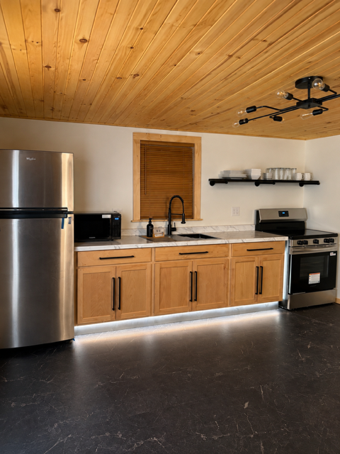 Full kitchen — wood cabinets and stainless appliances