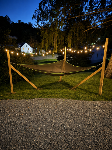 Hammock strung between wooden posts at dusk