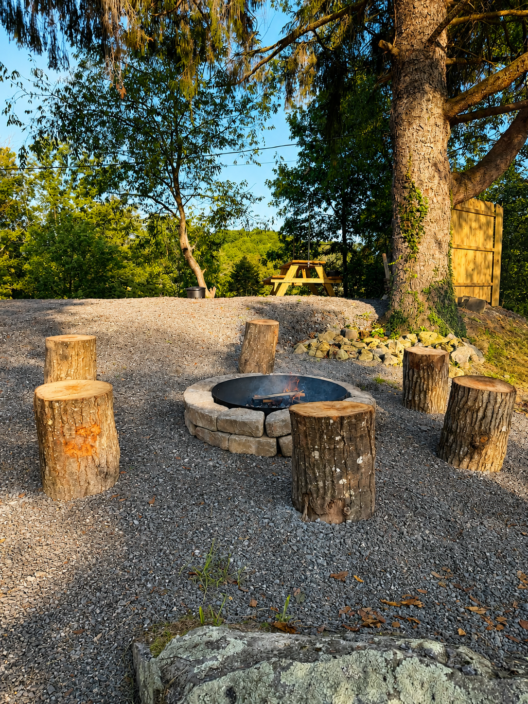 Rustic fire pit with log seating at night