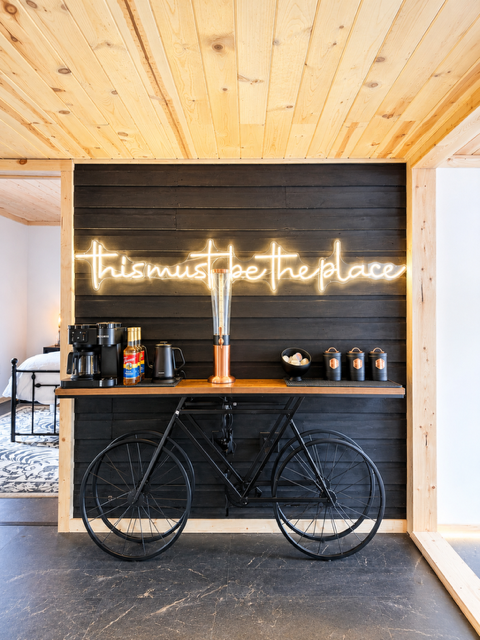 Coffee bar — neon sign above bicycle and coffee bar